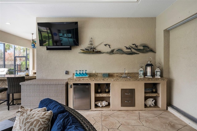 bar featuring fridge and sink