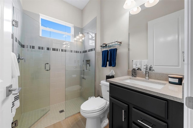 bathroom featuring vanity, wood-type flooring, toilet, and walk in shower