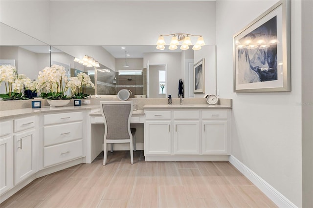 bathroom featuring vanity and tiled shower