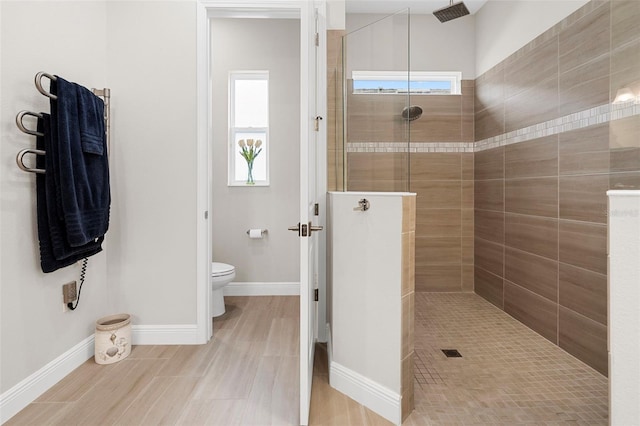 bathroom featuring toilet and tiled shower