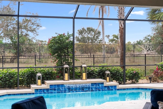 view of pool featuring glass enclosure