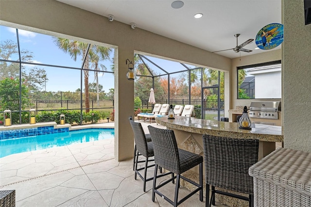 view of swimming pool with area for grilling, a patio area, and an outdoor bar