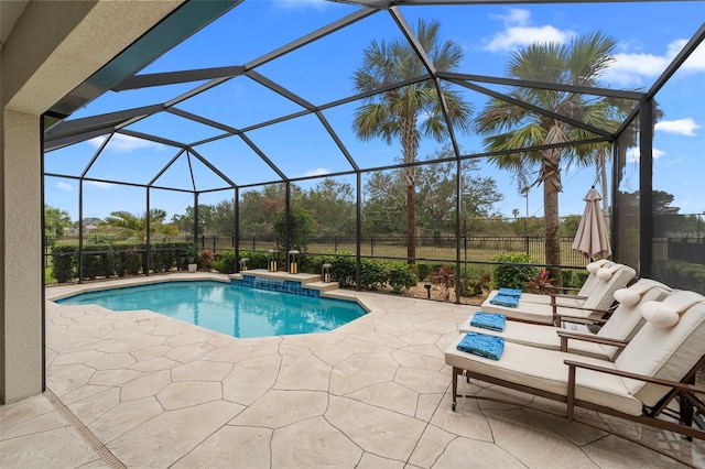 view of pool featuring a patio and glass enclosure