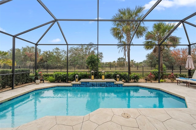 view of pool featuring pool water feature, a patio area, and glass enclosure