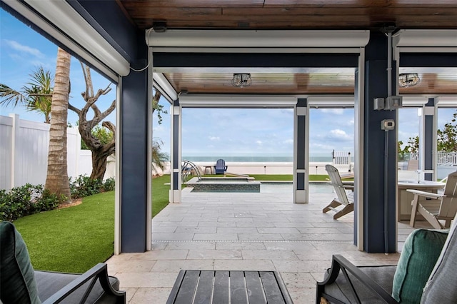 915 N Shore Dr, Anna Maria, FL 34216 - exterior space with an outdoor hot tub, a water view, and fence private yard