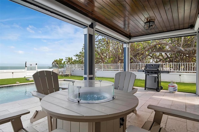 915 N Shore Dr, Anna Maria, FL 34216 - view of patio / terrace featuring fence, grilling area, outdoor dining area, a fenced in pool, and a water view