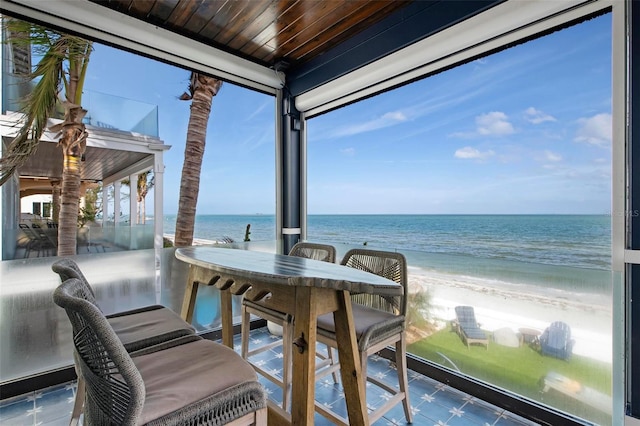 915 N Shore Dr, Anna Maria, FL 34216 - sunroom with a water view, wood ceiling, and a beach view