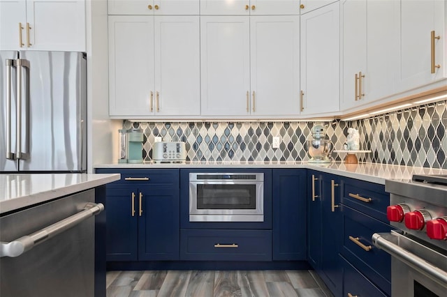 915 N Shore Dr, Anna Maria, FL 34216 - kitchen with light countertops, stainless steel appliances, white cabinetry, and blue cabinets