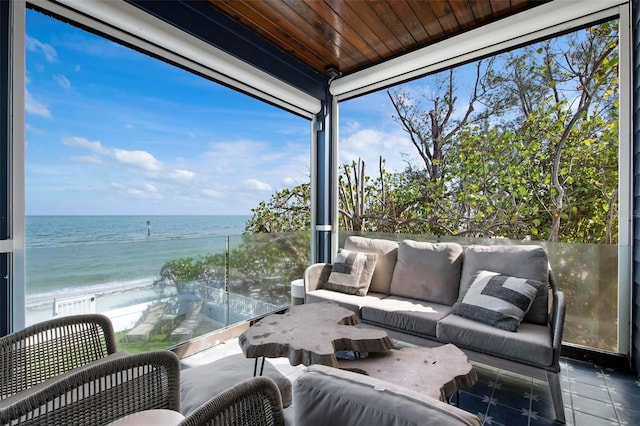 915 N Shore Dr, Anna Maria, FL 34216 - sunroom with a water view, floor to ceiling windows, and an outdoor hangout area