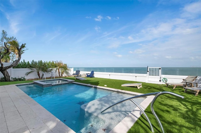915 N Shore Dr, Anna Maria, FL 34216 - view of pool with a fenced backyard, a water view, a yard, and a pool with connected hot tub