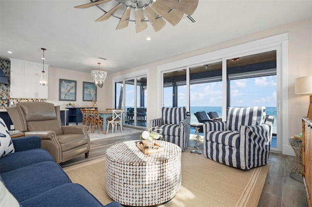915 N Shore Dr, Anna Maria, FL 34216 - living area with visible vents, recessed lighting, ceiling fan with notable chandelier, and wood finished floors