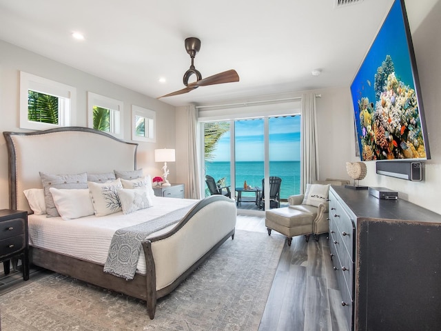 915 N Shore Dr, Anna Maria, FL 34216 - bedroom with access to exterior, recessed lighting, a ceiling fan, wood finished floors, and a water view
