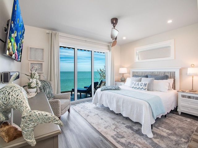 915 N Shore Dr, Anna Maria, FL 34216 - bedroom featuring recessed lighting, access to exterior, wood finished floors, and a water view
