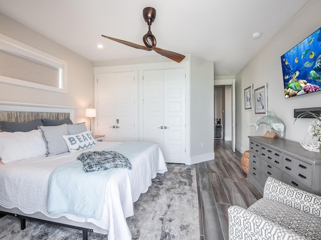 915 N Shore Dr, Anna Maria, FL 34216 - bedroom with wood finished floors, two closets, baseboards, ceiling fan, and recessed lighting