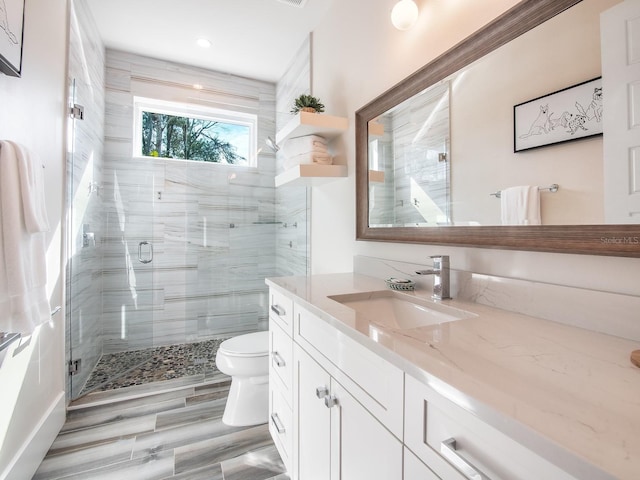 915 N Shore Dr, Anna Maria, FL 34216 - bathroom featuring recessed lighting, vanity, a stall shower, and toilet