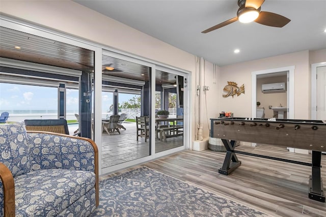 915 N Shore Dr, Anna Maria, FL 34216 - interior space featuring recessed lighting, ceiling fan, a wall unit AC, and wood finished floors