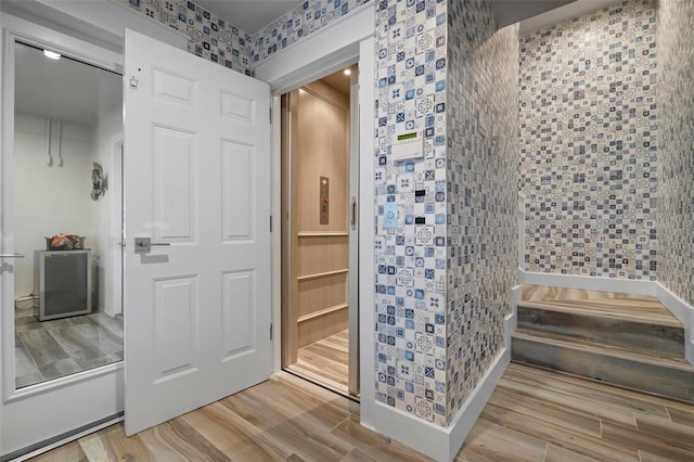 915 N Shore Dr, Anna Maria, FL 34216 - bathroom with wallpapered walls and wood finished floors