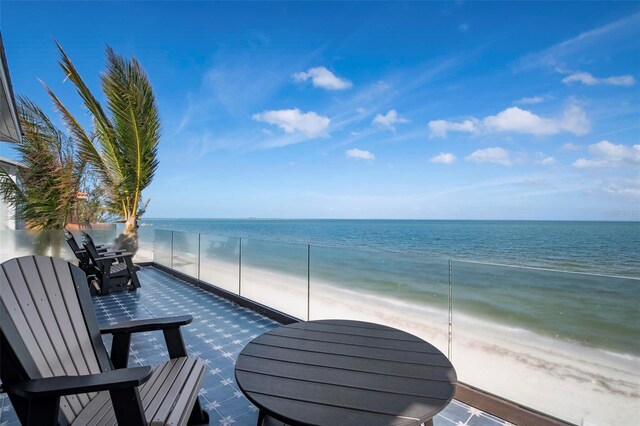 915 N Shore Dr, Anna Maria, FL 34216 - balcony with outdoor dining area, a water view, and a view of the beach