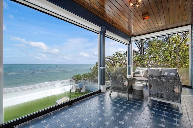 915 N Shore Dr, Anna Maria, FL 34216 - sunroom / solarium featuring a beach view, a water view, outdoor lounge area, and a wealth of natural light