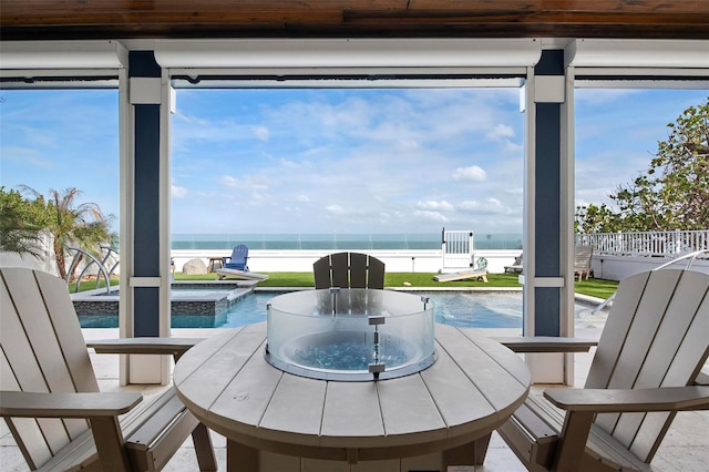 915 N Shore Dr, Anna Maria, FL 34216 - sunroom featuring a jacuzzi and a water view