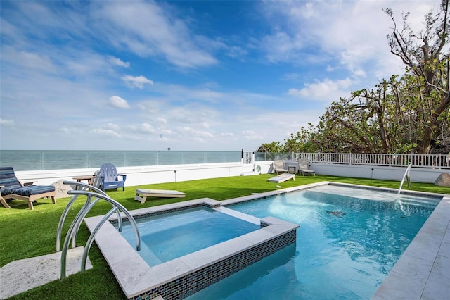 915 N Shore Dr, Anna Maria, FL 34216 - view of pool featuring a fenced backyard, a pool with connected hot tub, a yard, and a water view