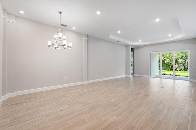8024 Moonbeam Ave, Sarasota, FL 34241 - spare room with a chandelier, baseboards, a raised ceiling, and recessed lighting