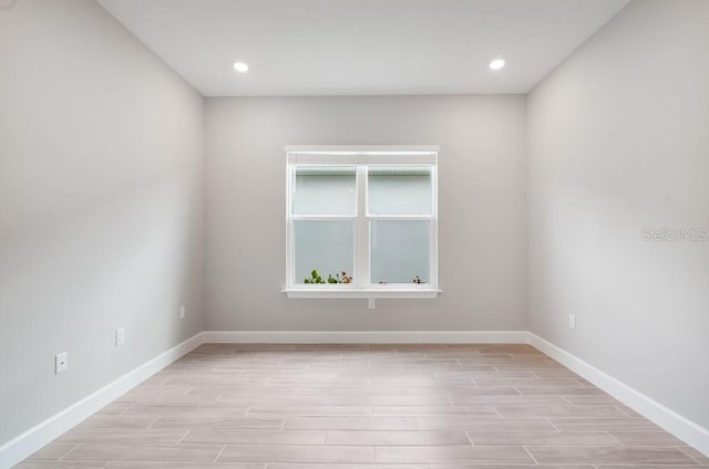8024 Moonbeam Ave, Sarasota, FL 34241 - unfurnished room with light wood-type flooring, baseboards, and recessed lighting