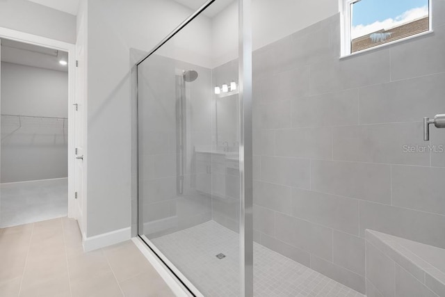 8024 Moonbeam Ave, Sarasota, FL 34241 - bathroom with a stall shower, a spacious closet, and tile patterned flooring