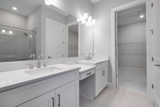 8024 Moonbeam Ave, Sarasota, FL 34241 - full bathroom featuring double vanity, a spacious closet, a stall shower, and tile patterned flooring
