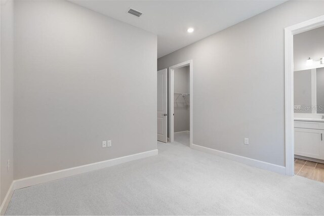 8024 Moonbeam Ave, Sarasota, FL 34241 - unfurnished room featuring light colored carpet, baseboards, and recessed lighting