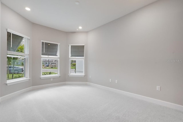 8024 Moonbeam Ave, Sarasota, FL 34241 - carpeted empty room with baseboards and recessed lighting