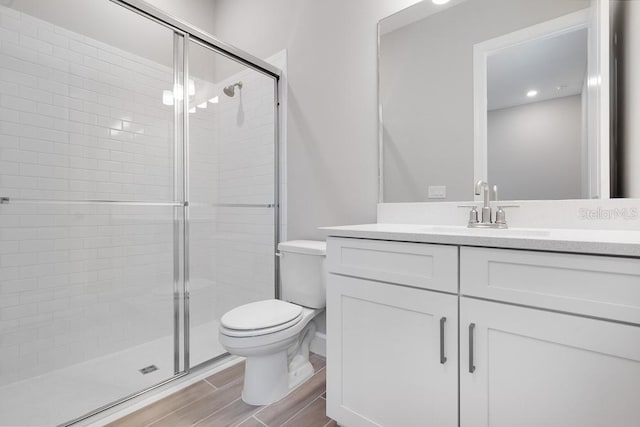 8024 Moonbeam Ave, Sarasota, FL 34241 - full bath with toilet, a shower stall, vanity, and wood tiled floors