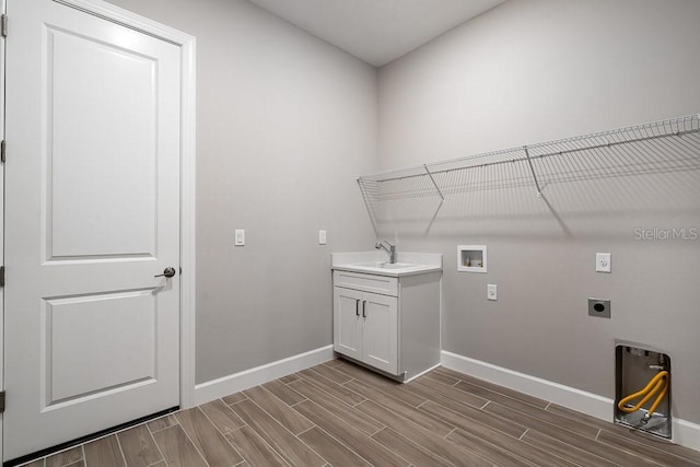 8024 Moonbeam Ave, Sarasota, FL 34241 - washroom with hookup for an electric dryer, baseboards, washer hookup, and wood finish floors