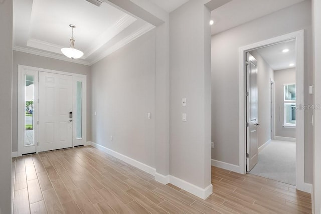 8024 Moonbeam Ave, Sarasota, FL 34241 - foyer entrance with crown molding, light wood-style floors, and baseboards
