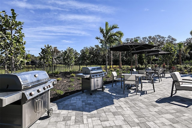 8024 Moonbeam Ave, Sarasota, FL 34241 - view of patio / terrace featuring a grill, view of scattered trees, and outdoor dining area