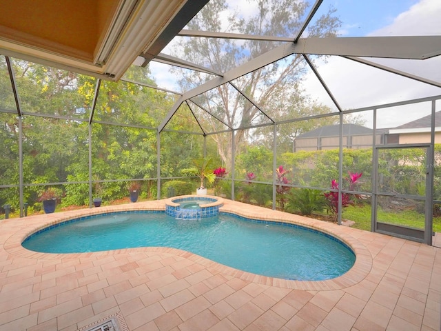 view of swimming pool with glass enclosure, an in ground hot tub, and a patio