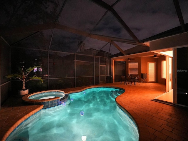 view of swimming pool featuring an in ground hot tub, glass enclosure, and a patio area