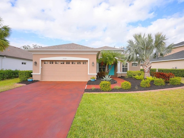 view of front of home featuring a garage and a front yard