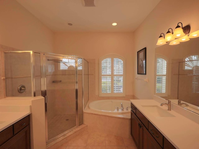 bathroom with plus walk in shower, a chandelier, tile patterned flooring, and vanity