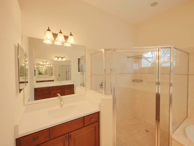 bathroom with vanity and shower with separate bathtub