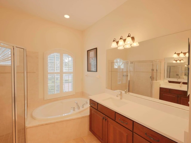 bathroom with independent shower and bath, tile patterned floors, and vanity