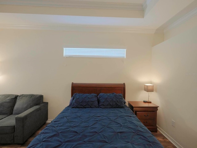 bedroom featuring crown molding and wood-type flooring