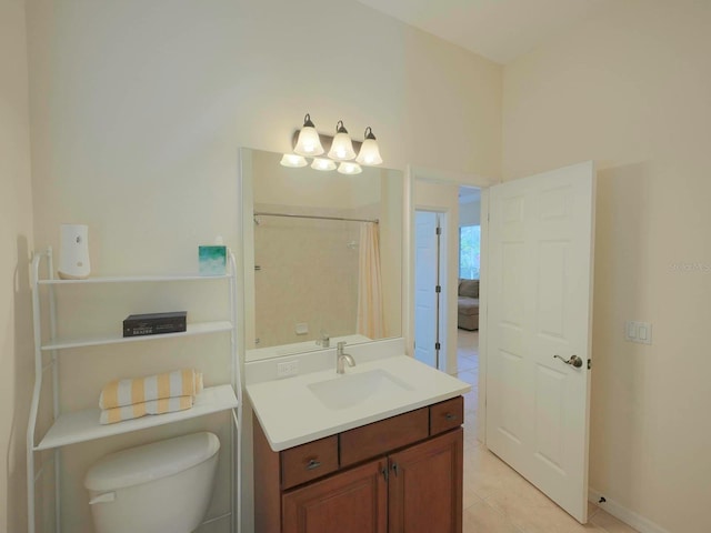 bathroom featuring tile patterned floors, toilet, vanity, and walk in shower