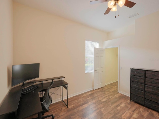 office with wood-type flooring and ceiling fan