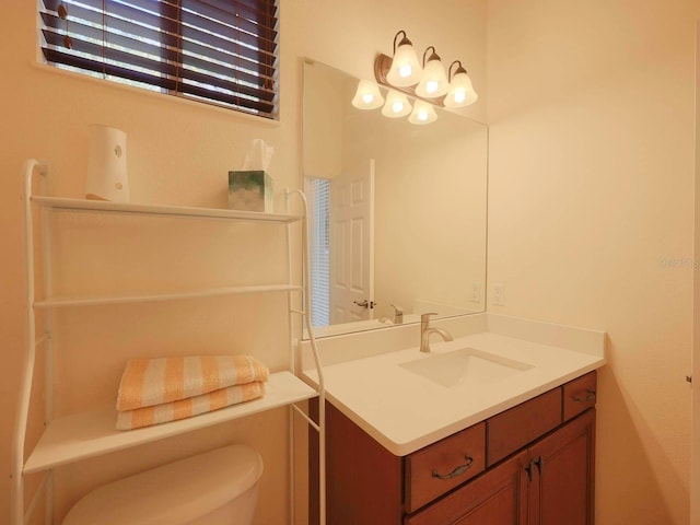 bathroom featuring toilet and vanity