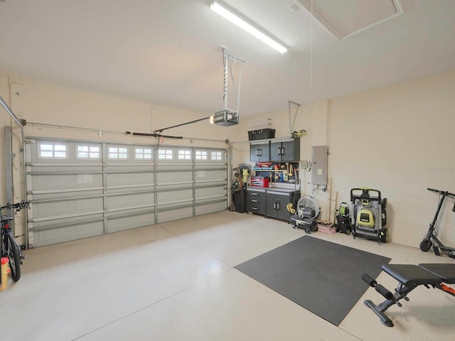 garage featuring electric panel and a garage door opener