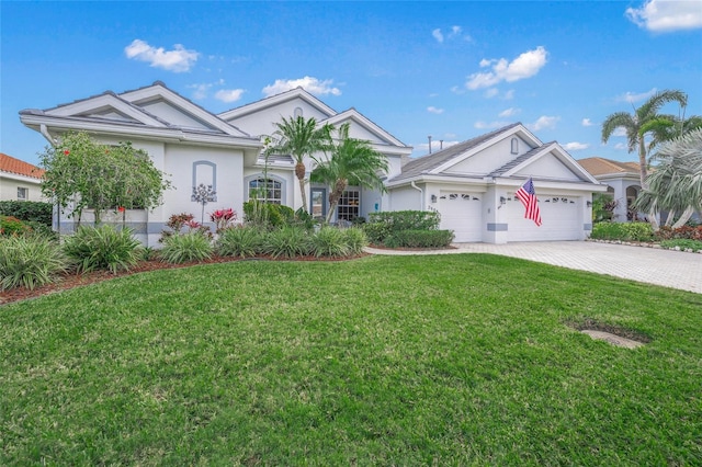 single story home with a garage and a front lawn