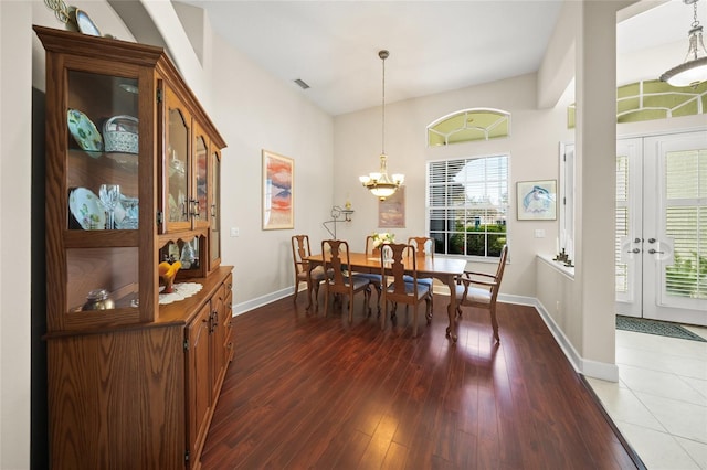 dining space with dark hardwood / wood-style floors and a chandelier