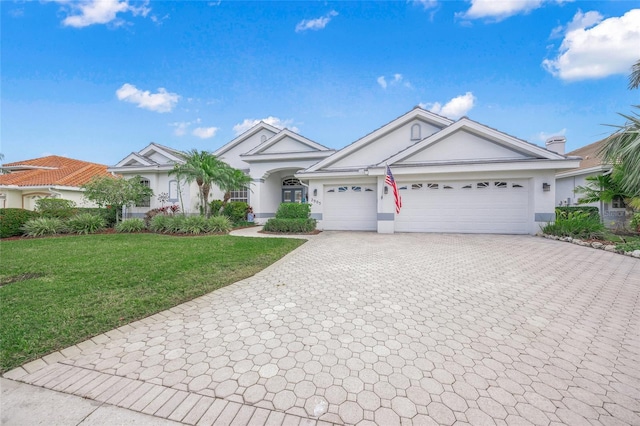 view of front of house with a front lawn and a garage