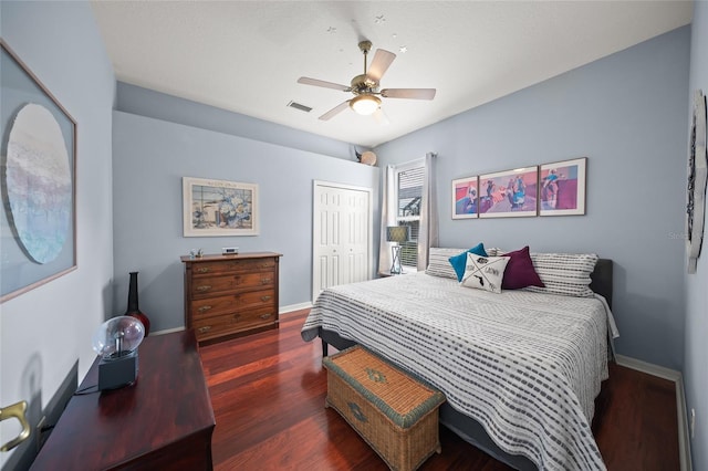 bedroom with ceiling fan, dark hardwood / wood-style flooring, and a closet